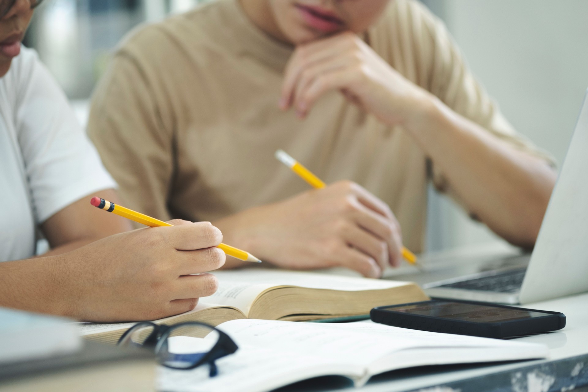Young students campus helps friend catching up and learning.